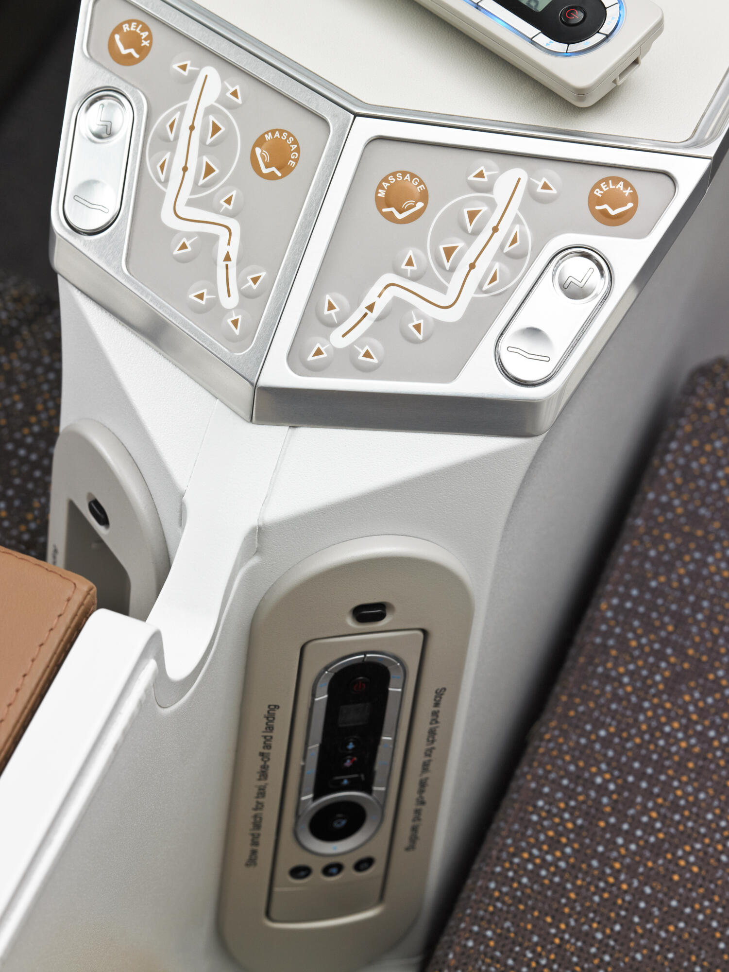Photographie professionnelle du panneau de contrôle et des fonctionnalités (massage, relax) d'un siège d'avion de classe premium. Image réalisée par Studio ZE, photographe d'objet technique et de service aérien à Toulouse.